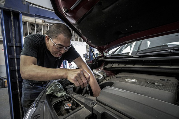 mechanic servicing a car at a workshop