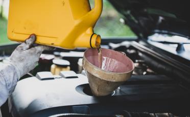 pouring engine oil into car