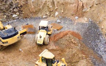 3 heavy equipment at mining site