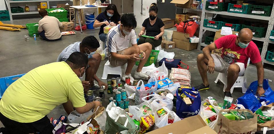 employees sorting out food at FoodBank warehouse
